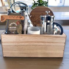 a wooden box filled with different types of coffee and condiments on top of a table