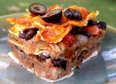 a close up of a plate of food with olives and other foods on it