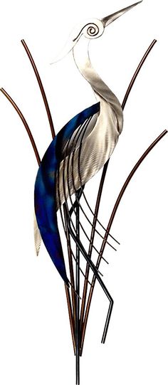 a glass bird sitting on top of a plant next to tall brown stems with blue leaves