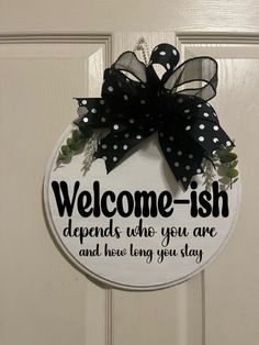 a welcome sign hanging on the front door