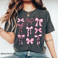 Our pink coquette bows shirt makes the perfect addition to your summer wardrobe.  You will love it! This shirt is made with a professional DTG Printing machine. Printed with eco-friendly water based inks that prints the image/designs on the shirt allowing the image to become part of the shirt so there is no peeling or cracking over time. If you have any questions please feel free to reach out and I will be happy to assist you.  HOW TO ORDER  1. Select the size and color of the shirt you would like to order. 2. Add the quantity of shirt(s) you would like and then click "Add to Cart" 3. Submit Order  4. During checkout please provide any additional information in the "Note to Seller" section. If you forget, just send me a message on Etsy after your order is completed.  PINK BOWS SHIRT DETAIL Pink T-shirt For Summer Gift, Cute Pink Party T-shirt, Pink Summer T-shirt For Gift, Pink Tops With Bow For Party, Pink Party Top With Bow, Cotton Summer Tops With Bow Print, Casual Summer T-shirt With Pink Bow, Casual Party Tops With Bow, Cute Pink T-shirt With Bow