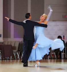 a man and woman dancing on a dance floor