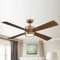 a ceiling fan with three wooden blades in a living room