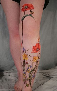 a woman's leg with flowers painted on it