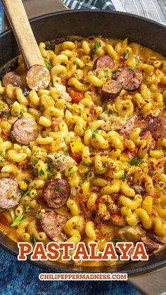 a skillet filled with pasta and sausage