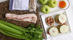 an assortment of food is laid out on a counter top, including broccoli and apples