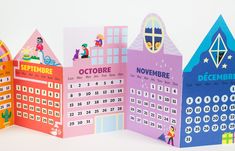 three colorful calendars are placed next to each other