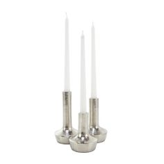 three silver candles sitting on top of each other