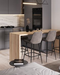 a modern kitchen with an island table and bar stools in the middle of it