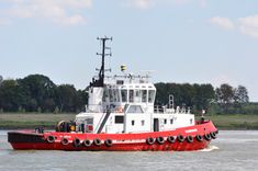 a large red and white boat in the water