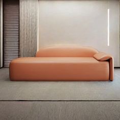 an orange couch sitting in the middle of a room