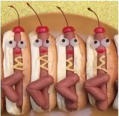 four hot dogs with googly eyes and buns in the shape of people's legs