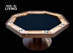 a round wooden table with metal studs on the top and black cloth in the middle