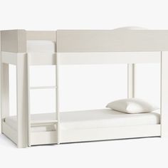 a white bunk bed with a pillow on it's bottom and the top half