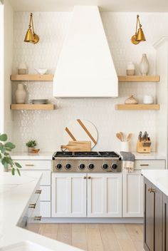 a kitchen with an oven, stove and shelves in the wall next to each other