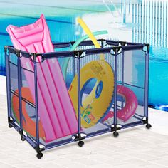 an outdoor swimming pool with toys in it and a child's playpen next to the pool