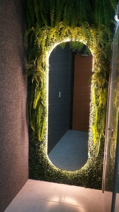 a mirror that is sitting in the middle of a room with plants growing on it