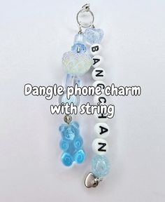 a cell phone charm with charms attached to it's sides and the words dangle phone charm with string