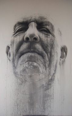 a drawing of a man's face is shown in black and white, as if it were painted on the wall