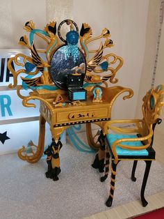 an elaborately decorated desk and chair are on display