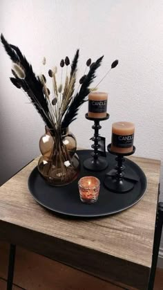 some candles are sitting on a black tray