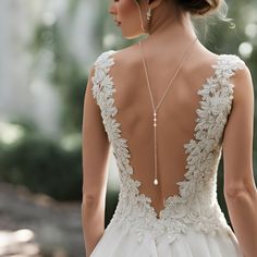 the back of a woman's wedding dress with an intricate beaded neckline