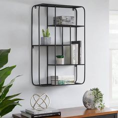 a shelf with some books and plants on it