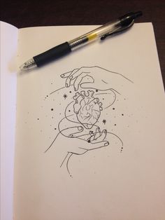 a drawing of a hand holding a heart on top of a book with a pen next to it