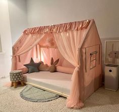 a child's bedroom with a pink canopy bed