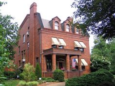 an old red brick house with many windows