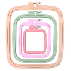 four pastel colored square shaped frames with metal clips on each side and one in the middle