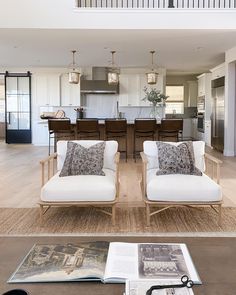 a living room filled with furniture and a book