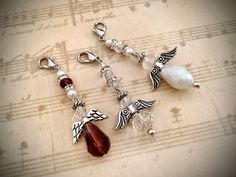 four charms are sitting on top of sheet music