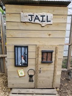 a small house made out of pallet wood with the word jail written on it