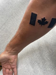 a person's arm with a canadian flag tattoo on it