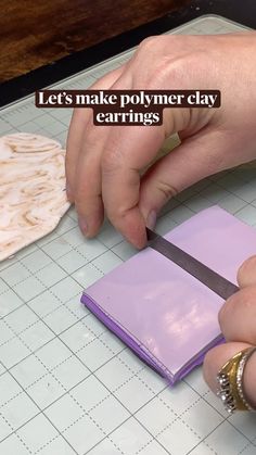 a person is cutting paper with a knife