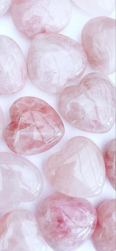 some pink rocks on a white surface