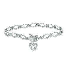 Dress her wrist with this charming bracelet for any special occasion. Crafted in sterling silver, this enchanting style features oval links alternating with heart-shaped stations adorned with diamond accents. At the clasp, a diamond-accented heart-shaped design and dangle heart charm complete this thoughtful look. Polished to a bright shine, this 7.25-inch bracelet secures with a box clasp. Silver Oval Link Diamond Bracelet For Anniversary, Silver Diamond Bracelet For Anniversary, Charms For Pandora Bracelet, Pandora Bracelet Charms, Jewelry Lookbook, Diamond Charm, Puffy Heart, Bracelets Jewelry, Heart Earrings Studs