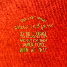 the words are written in green on an orange background with red and black lettering that says, true light draws others and gives us the courage and stand for them