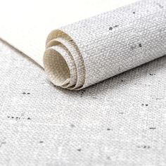 a roll of white fabric sitting on top of a table