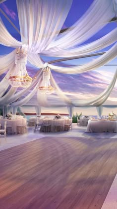 an image of a dance floor with white draping and chandeliers hanging from the ceiling