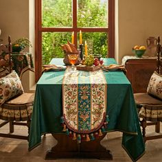 a dining room table with a green table cloth