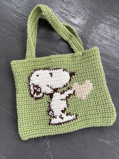 a crocheted bag with a snoopy dog on it