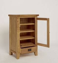 a wooden cabinet with its door open and shelves