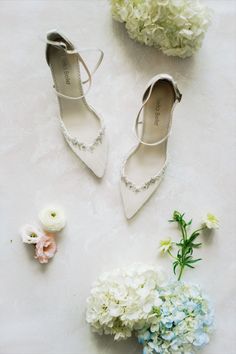 the bride's shoes and flowers are laid out for their wedding day, including hydrangeas