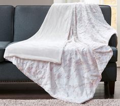 a couch with a white blanket on top of it