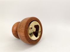 a close up of a wooden knob on a white background