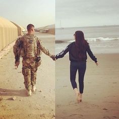 two people holding hands while walking on the beach next to an army man and woman