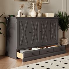 a living room with a gray cabinet and potted plants