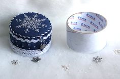 two rolls of toilet paper sitting next to each other on a snow covered tablecloth